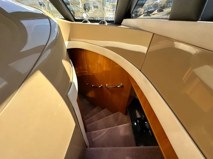  Yacht Photos Pics Interior staircase of 2001 Carver 570 Voyager Pilothouse yacht, featuring sleek wood paneling.