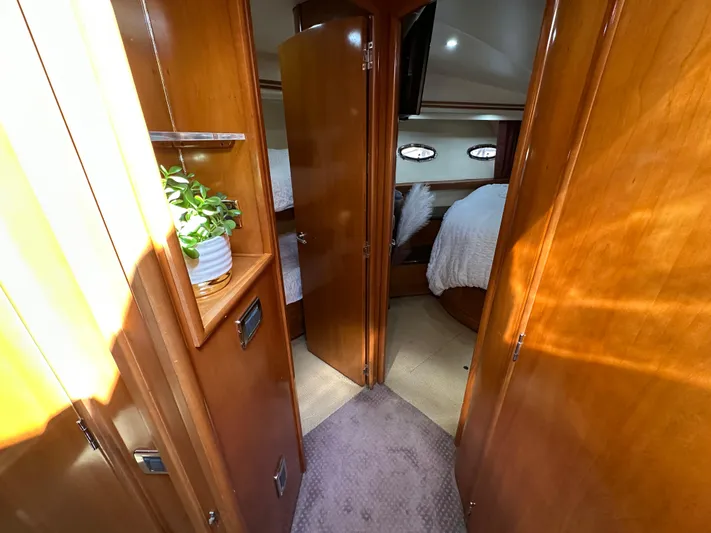  Yacht Photos Pics Interior of 2001 Carver 570 Voyager Pilothouse with wood paneling and cozy bedroom.