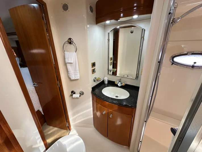  Yacht Photos Pics Luxurious bathroom in 2001 Carver 570 Voyager Pilothouse yacht with wood accents and modern fixtures.