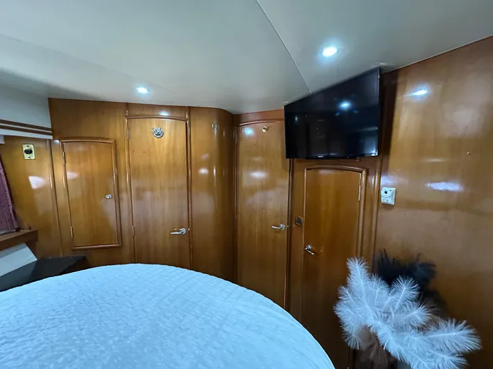  Yacht Photos Pics Luxurious interior of 2001 Carver 570 Voyager Pilothouse with wood paneling and mounted TV.