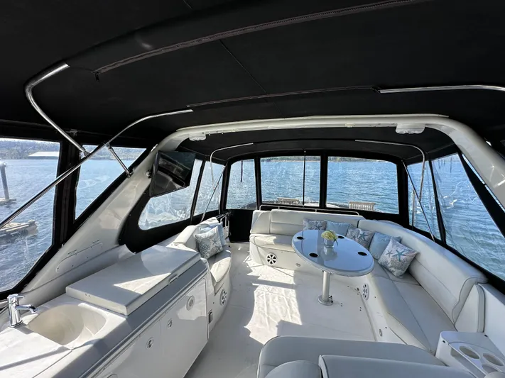  Yacht Photos Pics Luxurious interior of 2001 Carver 570 Voyager Pilothouse yacht with elegant seating and table.