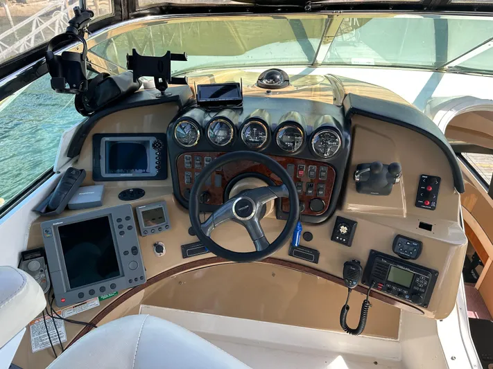  Yacht Photos Pics 2001 Carver 570 Voyager Pilothouse helm with navigation instruments and steering wheel.