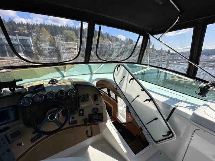  Yacht Photos Pics Pilothouse interior of 2001 Carver 570 Voyager yacht with scenic marina view.