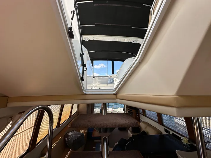  Yacht Photos Pics Interior view of 2001 Carver 570 Voyager Pilothouse, showcasing stairs and open hatch.