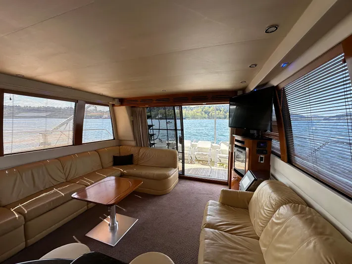  Yacht Photos Pics Luxurious interior of 2001 Carver 570 Voyager Pilothouse yacht with leather seating and lake view.