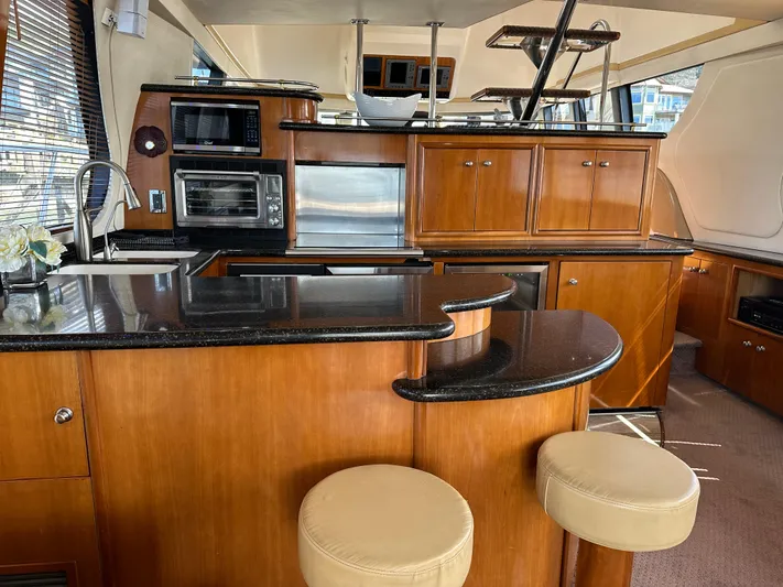  Yacht Photos Pics Luxurious 2001 Carver 570 Voyager Pilothouse interior with modern kitchen and seating area.