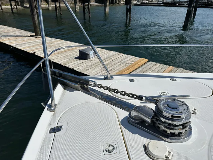  Yacht Photos Pics Bow of 2001 Carver 570 Voyager Pilothouse with anchor chain and winch at dock.