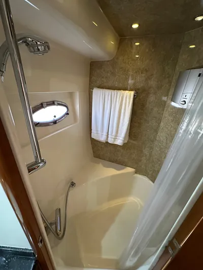  Yacht Photos Pics Bathroom in 2001 Carver 570 Voyager Pilothouse yacht, featuring shower and towel rack.