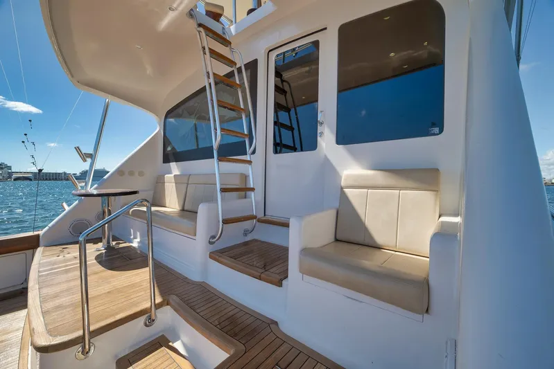 Monkey Business Yacht Photos Pics 2010 Viking 82 Convertible yacht deck with seating and ladder, overlooking the water.