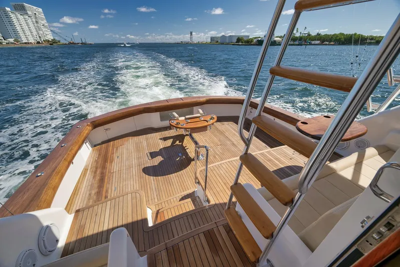 Monkey Business Yacht Photos Pics Luxurious 2010 Viking 82 Convertible yacht deck with wooden flooring and ocean view.