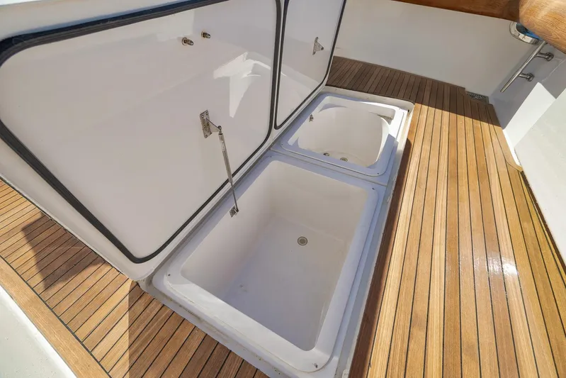Monkey Business Yacht Photos Pics Open storage compartments on 2010 Viking 82 Convertible yacht with teak flooring.