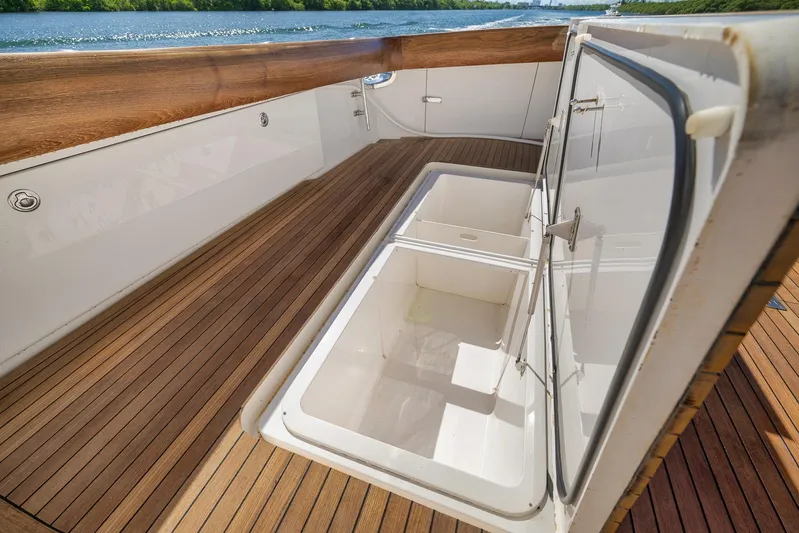 Monkey Business Yacht Photos Pics Open storage compartment on 2010 Viking 82 Convertible yacht with wooden deck.