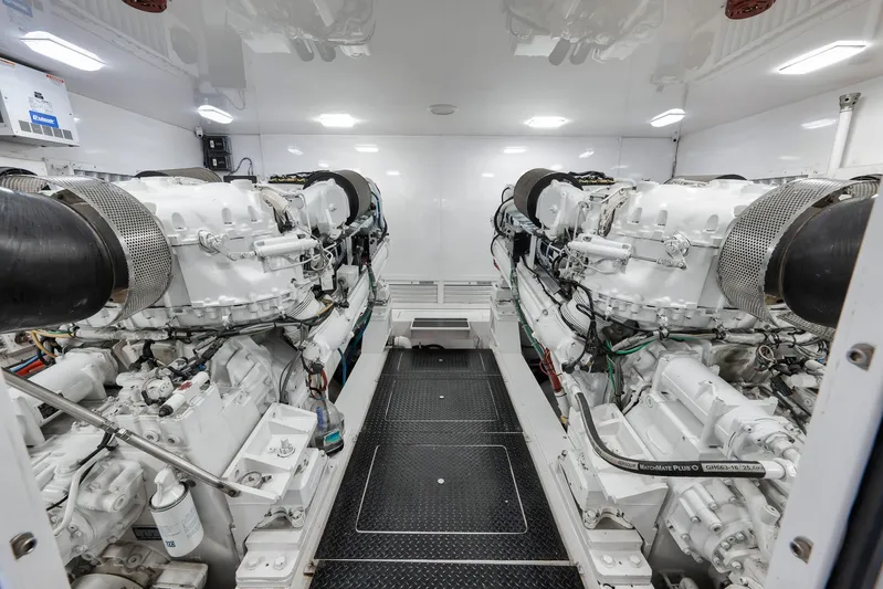 Monkey Business Yacht Photos Pics Engine room of 2010 Viking 82 Convertible yacht, featuring dual powerful engines.