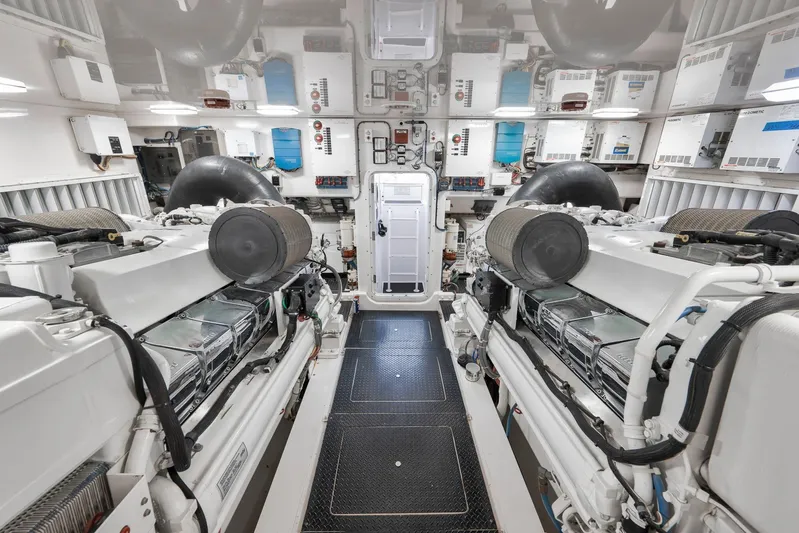 Monkey Business Yacht Photos Pics Engine room of 2010 Viking 82 Convertible yacht, showcasing dual engines and advanced equipment.