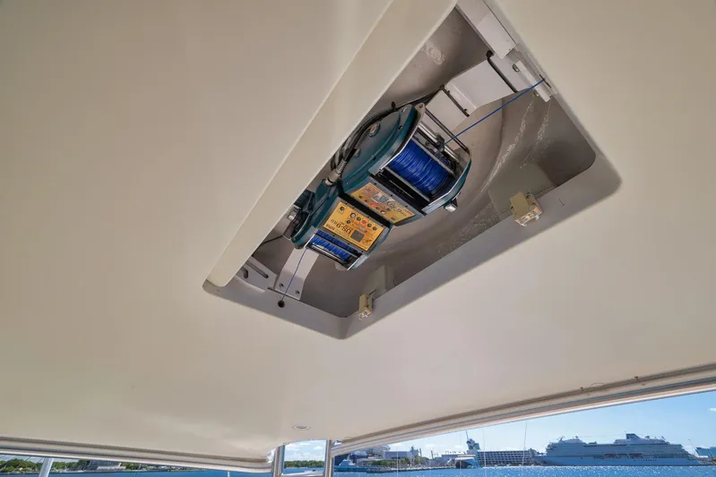 Monkey Business Yacht Photos Pics Ceiling-mounted equipment on 2010 Viking 82 Convertible yacht, featuring a blue cable reel.