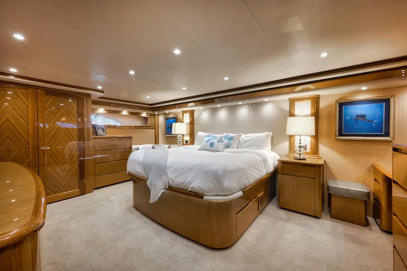 Monkey Business Yacht Photos Pics Luxurious bedroom interior of 2010 Viking 82 Convertible yacht with elegant wood finishes.