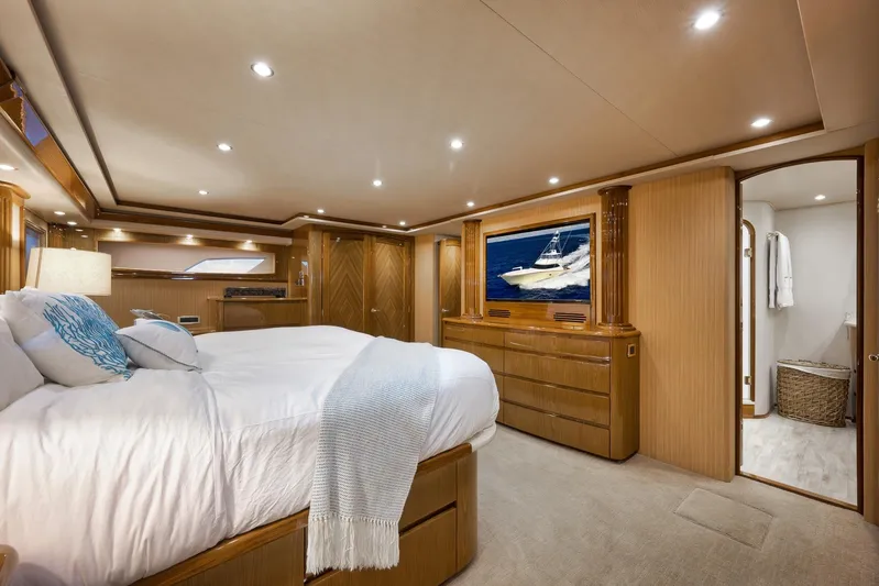 Monkey Business Yacht Photos Pics Luxurious bedroom interior of 2010 Viking 82 Convertible yacht with elegant wood finishes.