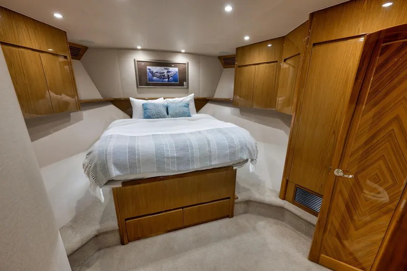 Monkey Business Yacht Photos Pics Luxurious bedroom interior of 2010 Viking 82 Convertible yacht with wooden cabinetry.