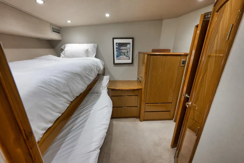 Monkey Business Yacht Photos Pics Interior of 2010 Viking 82 Convertible yacht with bunk beds and wooden cabinetry.
