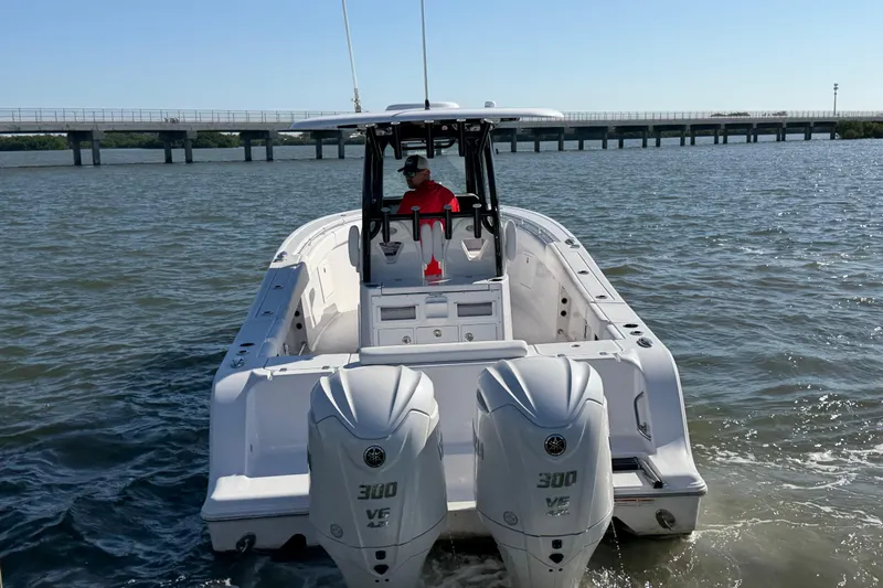  Yacht Photos Pics 2024 Sportsman Open 282TE Center Console boat on water, bridge in background.