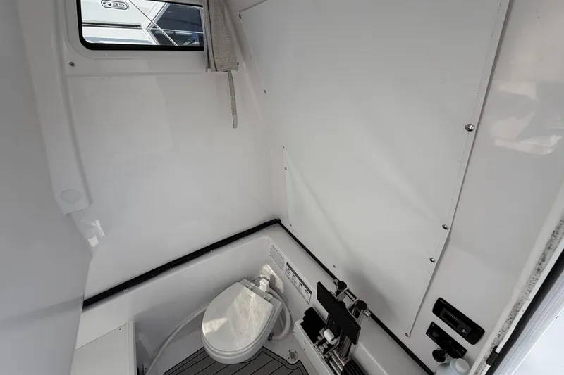  Yacht Photos Pics 2024 Sportsman Open 282TE Center Console interior with marine toilet and storage.