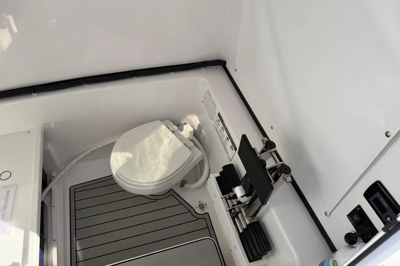  Yacht Photos Pics 2024 Sportsman Open 282TE Center Console boat interior with toilet and equipment.