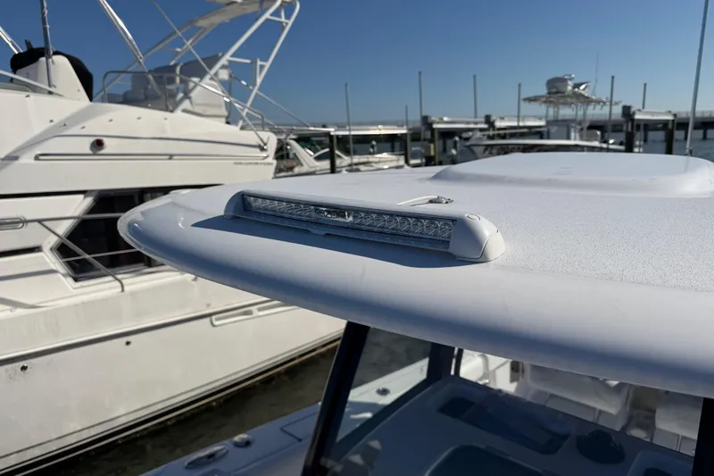  Yacht Photos Pics 2024 Sportsman Open 282TE Center Console boat with sleek design at marina.