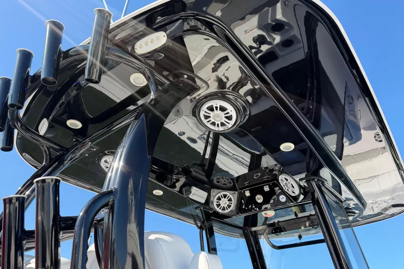  Yacht Photos Pics 2024 Sportsman Open 282TE Center Console, sleek black T-top with speakers and rod holders.