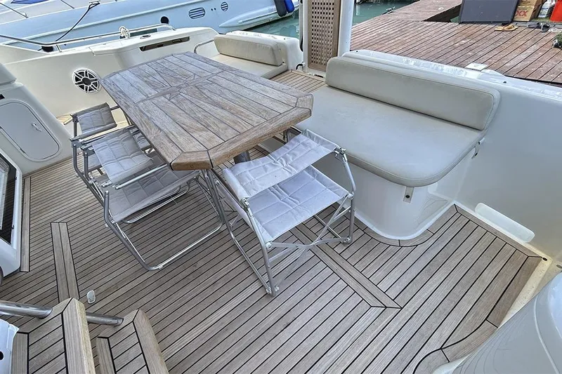 2008 Ferretti 510 Fly @ Cancun Yacht Photos Pics Luxury 2008 Ferretti Yachts 510 deck with wooden table and seating area.