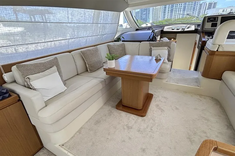 2008 Ferretti 510 Fly @ Cancun Yacht Photos Pics Luxurious interior of 2008 Ferretti Yachts 510 with elegant seating and wooden table.