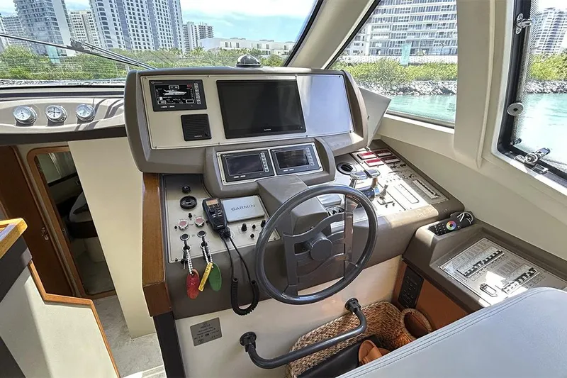 2008 Ferretti 510 Fly @ Cancun Yacht Photos Pics Helm of 2008 Ferretti Yachts 510 with modern navigation equipment and cityscape view.