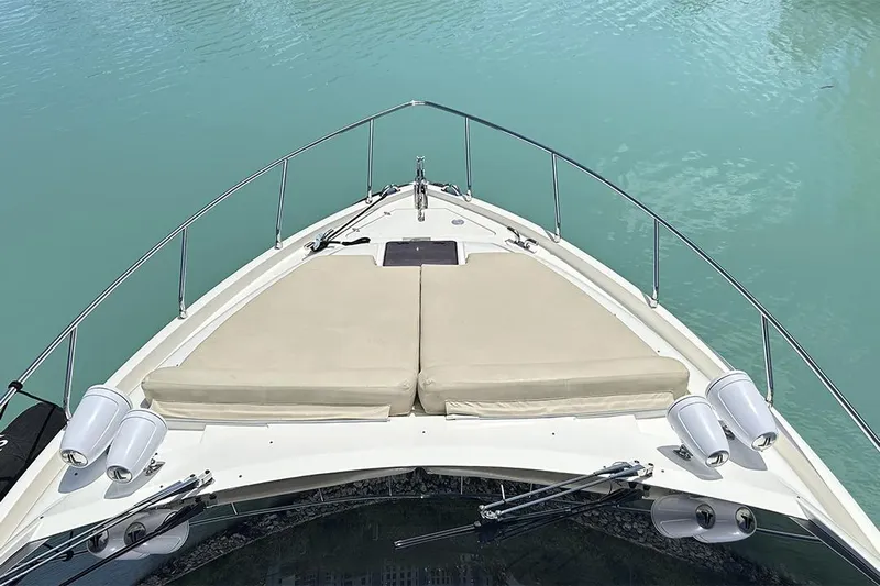 2008 Ferretti 510 Fly @ Cancun Yacht Photos Pics Bow view of 2008 Ferretti Yachts 510, featuring sun pads and calm turquoise water.