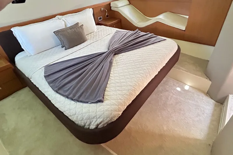 2008 Ferretti 510 Fly @ Cancun Yacht Photos Pics Luxurious bedroom interior of 2008 Ferretti Yachts 510 with elegant bedding and modern design.