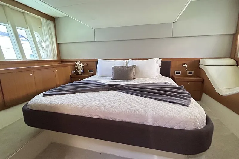 2008 Ferretti 510 Fly @ Cancun Yacht Photos Pics Luxurious bedroom interior of 2008 Ferretti Yachts 510 with elegant bedding and wood accents.