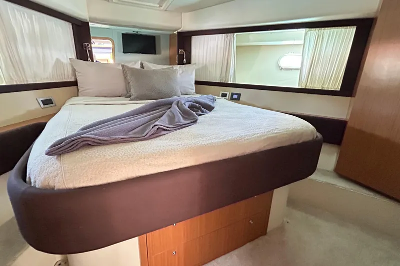2008 Ferretti 510 Fly @ Cancun Yacht Photos Pics Luxurious bedroom interior of 2008 Ferretti Yachts 510 with cozy bedding and elegant design.