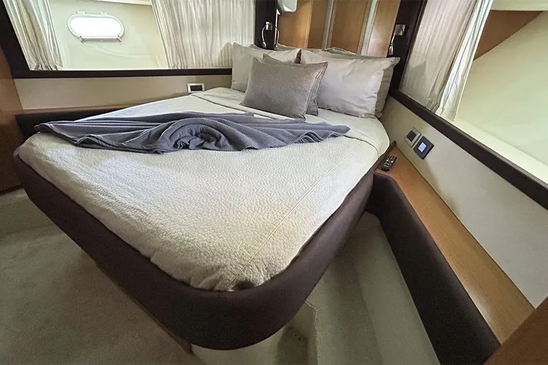 2008 Ferretti 510 Fly @ Cancun Yacht Photos Pics Luxurious bedroom interior of 2008 Ferretti Yachts 510 with elegant bedding and modern design.