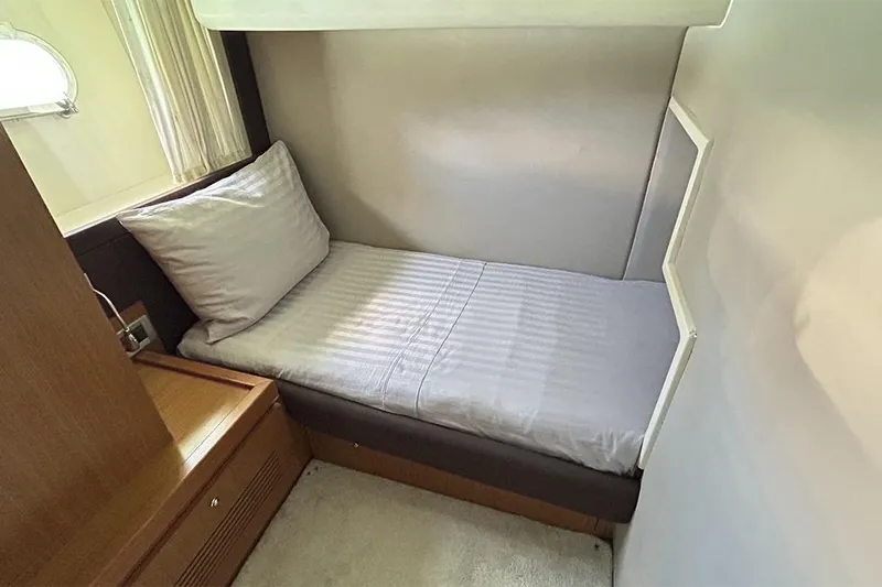 2008 Ferretti 510 Fly @ Cancun Yacht Photos Pics 2008 Ferretti Yachts 510 cabin interior with single bed and wooden furnishings.