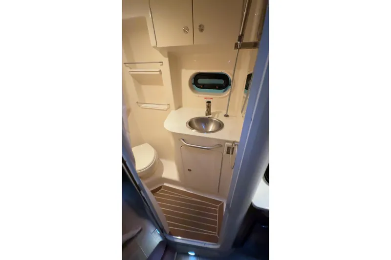  Yacht Photos Pics Compact bathroom in 2017 Sea Ray 330 Sundancer yacht with sink and toilet.