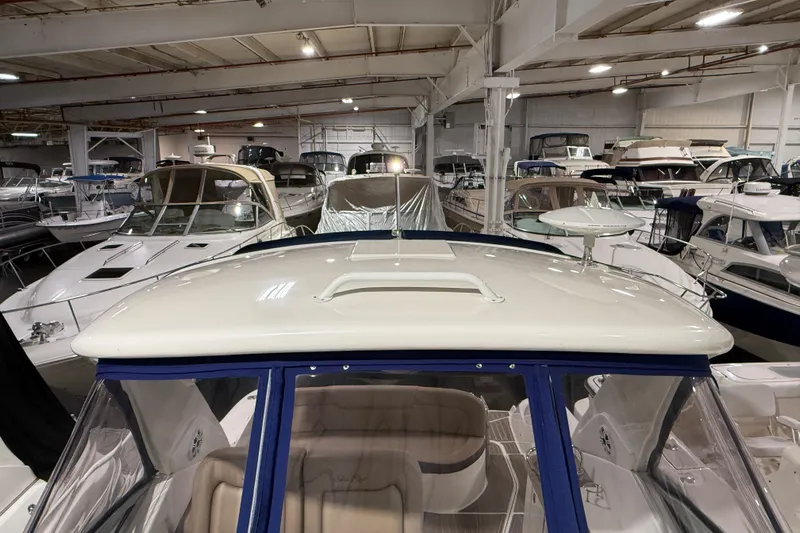  Yacht Photos Pics 2017 Sea Ray Sundancer 330 in a boat showroom, surrounded by various yachts.