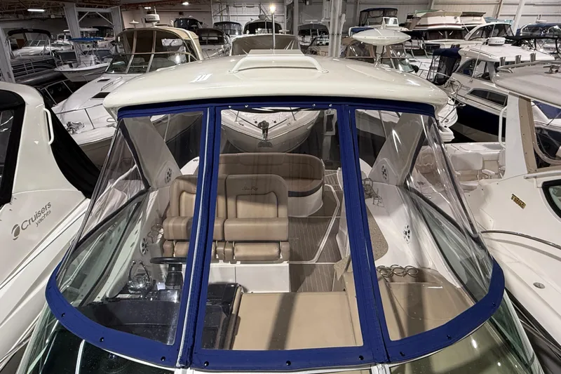  Yacht Photos Pics 2017 Sea Ray Sundancer 330 yacht in a showroom, surrounded by other boats.