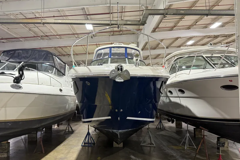  Yacht Photos Pics 2017 Sea Ray Sundancer 330 yacht in indoor storage, flanked by other boats.