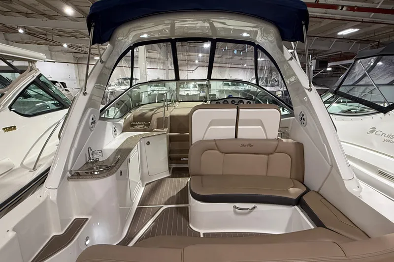  Yacht Photos Pics 2017 Sea Ray Sundancer 330 interior with seating and helm, showcased in a marina setting.