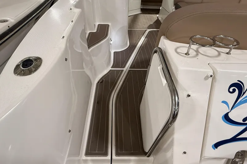  Yacht Photos Pics 2017 Sea Ray Sundancer 330 boat interior with brown flooring and stainless steel accents.