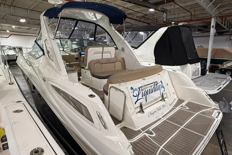  Yacht Photos Pics 2017 Sea Ray Sundancer 330 yacht in a showroom, featuring elegant seating and sleek design.