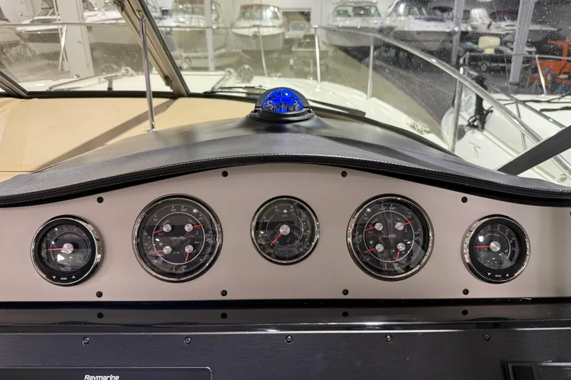 Yacht Photos Pics Dashboard of a 2017 Sea Ray Sundancer 330 with multiple gauges and a compass.
