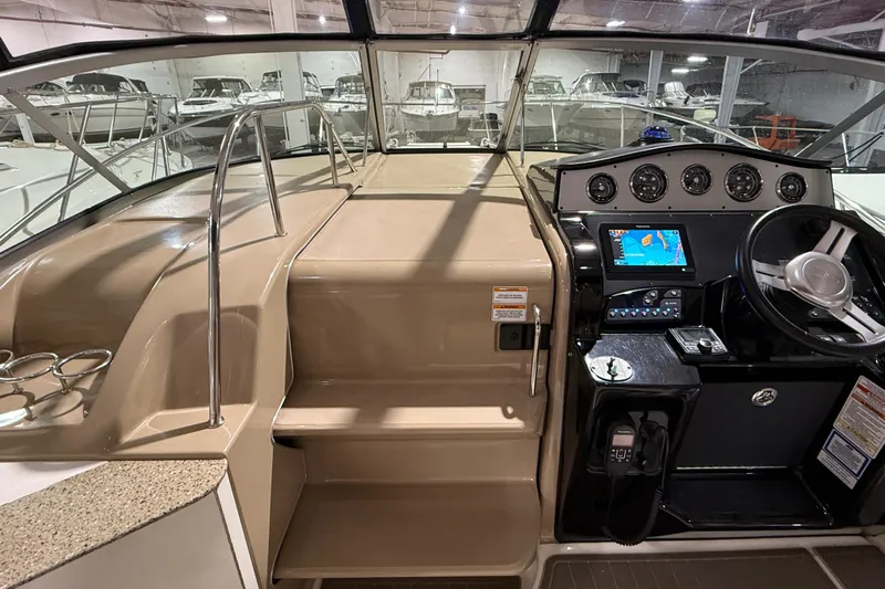 Yacht Photos Pics 2017 Sea Ray Sundancer 330 helm with navigation system and steering wheel in a showroom.