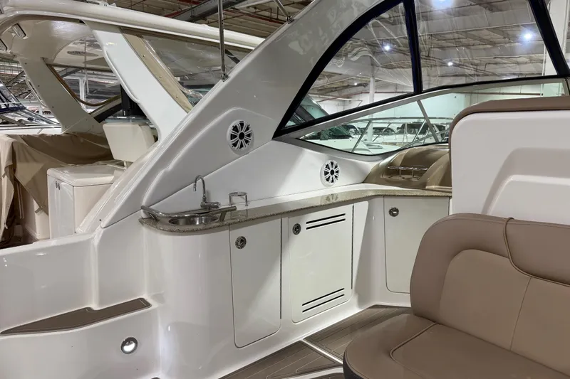  Yacht Photos Pics 2017 Sea Ray Sundancer 330 interior with seating, sink, and storage in a showroom.