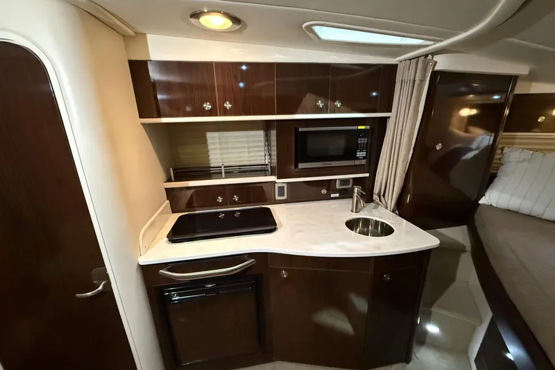  Yacht Photos Pics 2017 Sea Ray Sundancer 330 interior kitchen with microwave, sink, and stove.