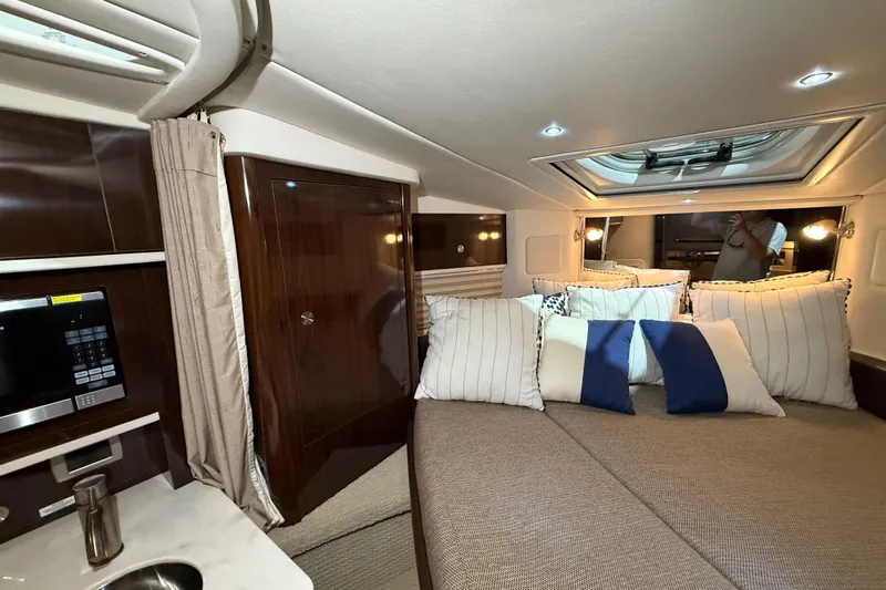 Yacht Photos Pics Luxurious interior of 2017 Sea Ray Sundancer 330 yacht with cozy bedding and modern amenities.