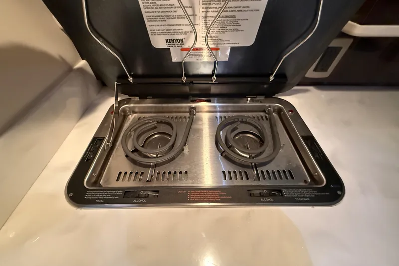  Yacht Photos Pics Built-in stove on 2017 Sea Ray Sundancer 330 yacht, featuring dual burners and stainless steel finish.